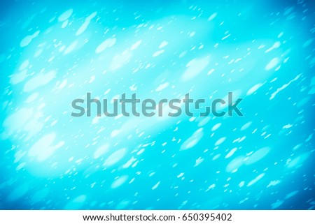 Abstract bokeh or glitter lights on blue  background. Circles and defocused particles. Design template