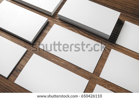 Photo of blank business cards on wooden background. Template for placing your design. Responsive design mockup.
