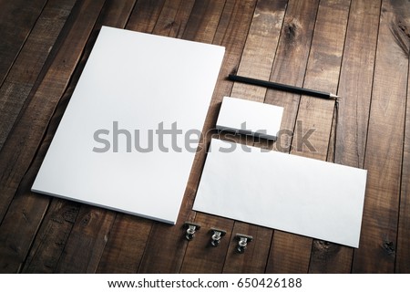 Photo of blank stationery set on wood background. Envelope, business cards, pencil, and A4 paper. Corporate identity template. Responsive design mockup. Royalty-Free Stock Photo #650426188