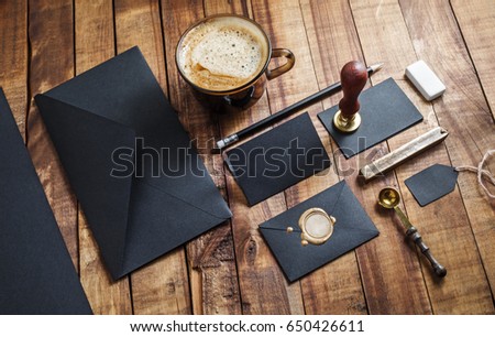 Set of black stationery elements on vintage wood table background. Branding template Photo of blank stationery. Mock-up for your design.