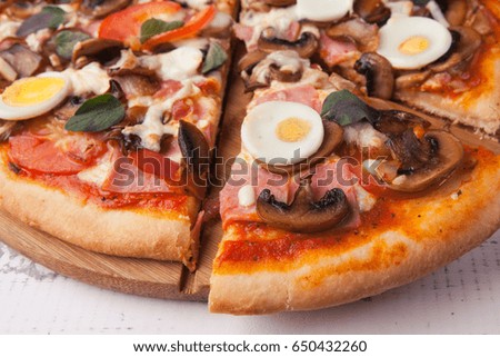 Pizza with mushrooms. Italian kitchen, close-up.
