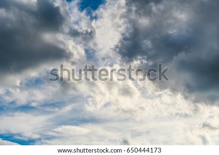 Bright contrasting gray clouds in the blue sky