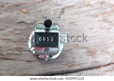 hand held counter on the old wooden table with nice background