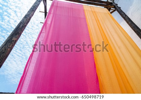 colorful fabric hanging to dry after traditional dye process,shot in Heng Dian Town,Zhejiang province of China.