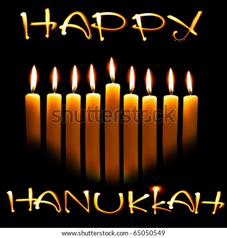 Created by light text Happy Hanukkah and candles over black background