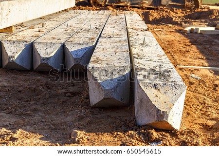 Concrete pile foundation for the building. Reinforced concrete piles on new construction site. Royalty-Free Stock Photo #650545615