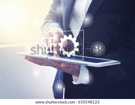 SEO graphic design on businessman using digital tablet , Search Engine Optimization concept.