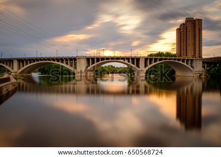 A reflection of the Third Avenue bridge over the Mississippi River as the sun sets
