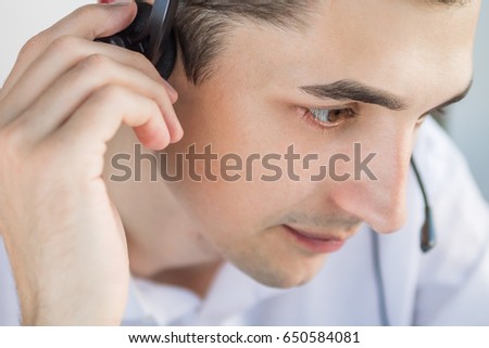 Call center agent talking to a client using headset Royalty-Free Stock Photo #650584081