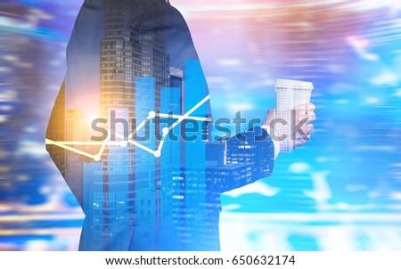 Close up of a businessman in a black suit standing with coffee in his hands in a city with blue and red blurred background. Graphs. Toned image double exposure