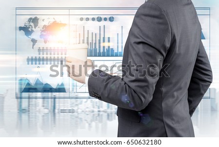 Close up of a businessman in a black suit standing with coffee in his hands in a city with blue graphs and a world map. Toned image double exposure. Elements of this image furnished by NASA