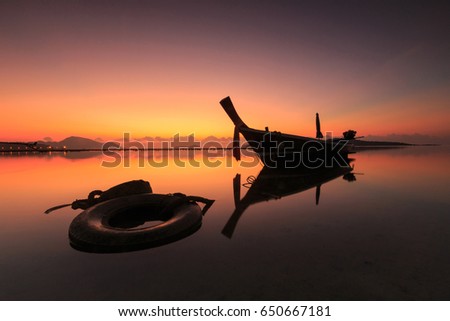 Fishing Boat at beach on sunrise
