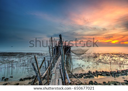 Long exposure image of "langgai" during beautiful sunset , the traditional fishing medium at Malaysia  