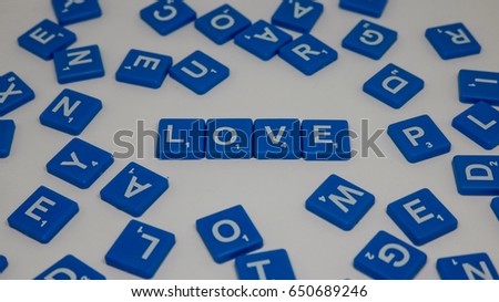 Crossword with blocks spelling LOVE words on  white background.