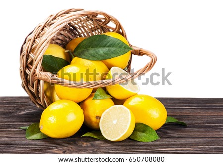 ripe lemons in the basket on the table isolated on white background 