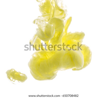 Yellow acrylic color. Ink swirling in water. Color explosion