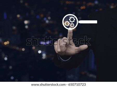 Businessman pressing seo flat icon over blur colorful night light city tower, Search engine optimization concept