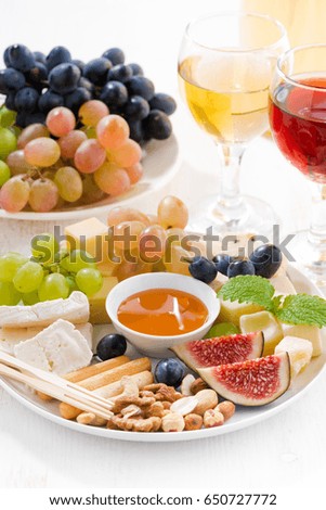 cheeses, fruits, wine and snacks, closeup vertical, top view