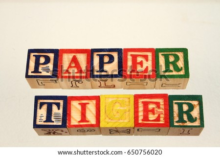 The term paper tiger displayed visually using colorful wooden blocks