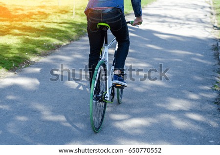 A man on a bicycle in the park. Close up