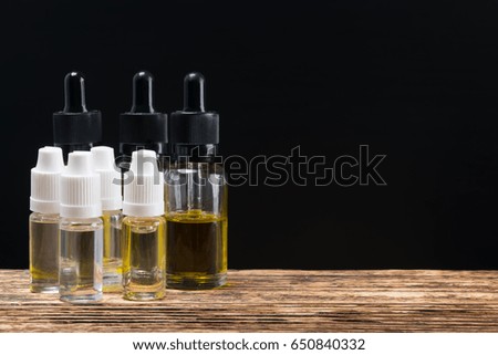 Bubbles with liquid for electronic cigarettes in stock on the table