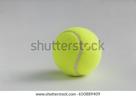 Single yellow tennis ball on the background close up