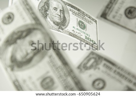 Finance concept. Money rain. Hundred dollar banknotes isolated on white background. Money concept. Stack growing business. Lens flare in the background.