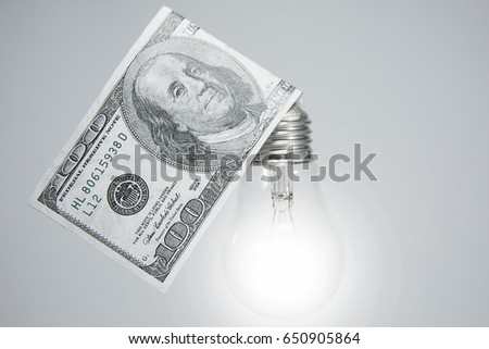 Having an idea. Light bulb moment. Good business idea. Lightbulb and money.