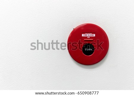red fire alarm on white concrete background. over light