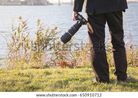 A photographer holding his camera