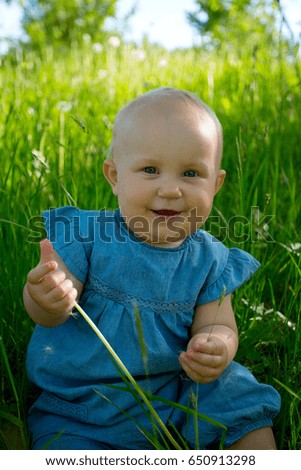 cute baby girl on a summer field