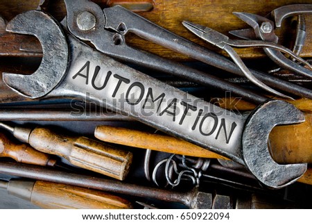 Photo of various tools and instruments with AUTOMATION letters imprinted on a clear wrench surface
