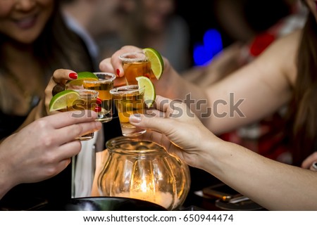 Girls making a toast with tequila shots Royalty-Free Stock Photo #650944474