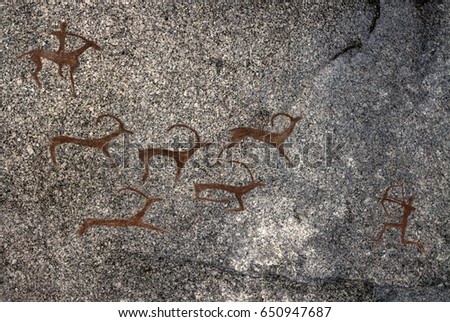 Picture in the cave. Rock paintings. Made on the wall with ocher paints. Hunting of an ancient man. 