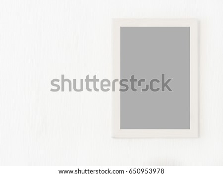 Light  wooden frame with blank picture isolated on white wall.Template for  graphic designers, presentations and portfolios