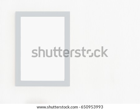 Light  wooden frame with blank picture isolated on white wall.Template for  graphic designers, presentations and portfolios 