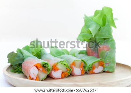 Salad roll on a wood dish in white background