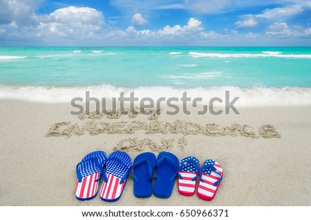 Independence USA  background with flip flops of american flag colors on the sandy beach near ocean 
