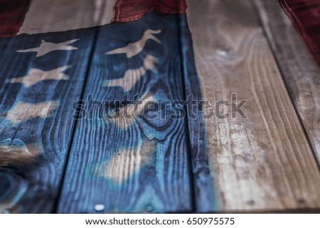 Vintage American Flag painted on aged, weathered rustic wooden Background.