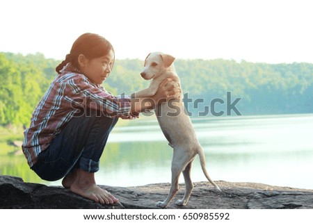 A girl and her dog enjoying travel in nature background  the sunset, color of vintage tone and soft focus