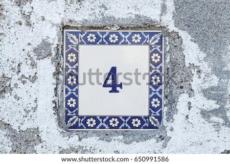 Traditional mediterranean greek pattern on a modern tile with digit 4 on it indicating a house number  