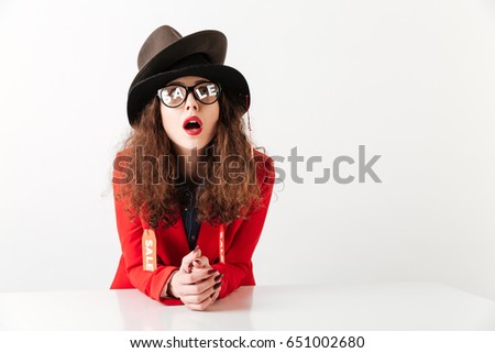 Excited stylish shopaholic woman wearing bright clothes with sale labels isolated over white background