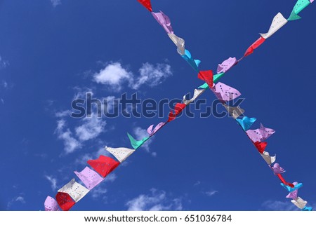 Traditional mexican paper bunting decoration celebratory flags against blue sky