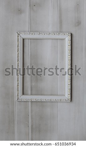 White, old, victorian, baroque frame on an old, weathered, white wall
