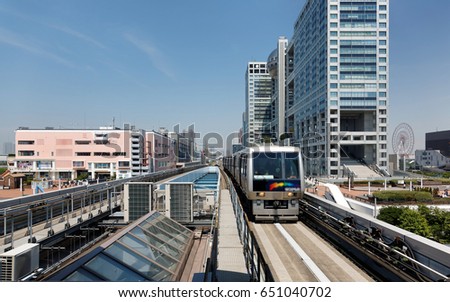 Scenery of a train traveling on the elevated rail of Yurikamome Line, passing by the famous landmark Fuji TV Building in Odaiba, Minato, Tokyo, under blue clear sunny sky (colorful painting version) Royalty-Free Stock Photo #651040702