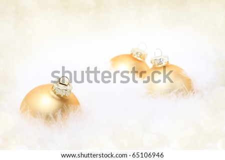 Golden baubles in white feather