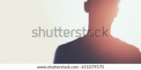 silhouette of unknown man with sun flares Royalty-Free Stock Photo #651079570