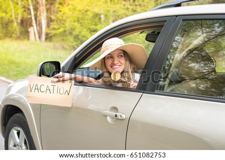 beautiful young woman in the nice car is going to vacation to the beach