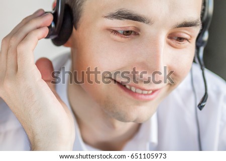 Call center agent talking to a client using headset Royalty-Free Stock Photo #651105973