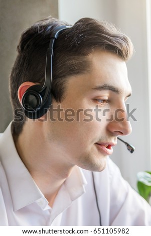 Call center agent talking to a client using headset Royalty-Free Stock Photo #651105982